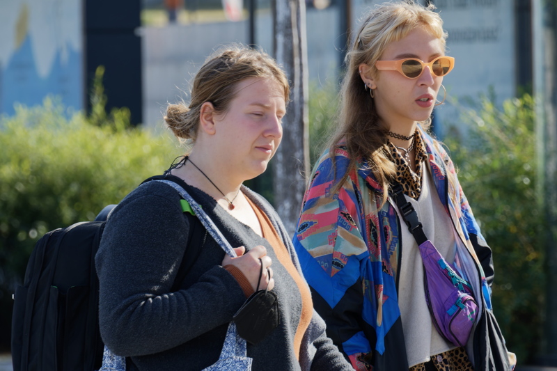 30 - Two young women in casual wear walking outdoors